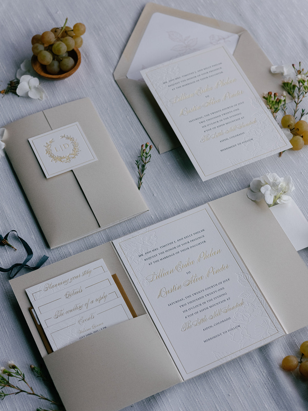 Wedding invitation set with envelopes and stationery on a light surface.