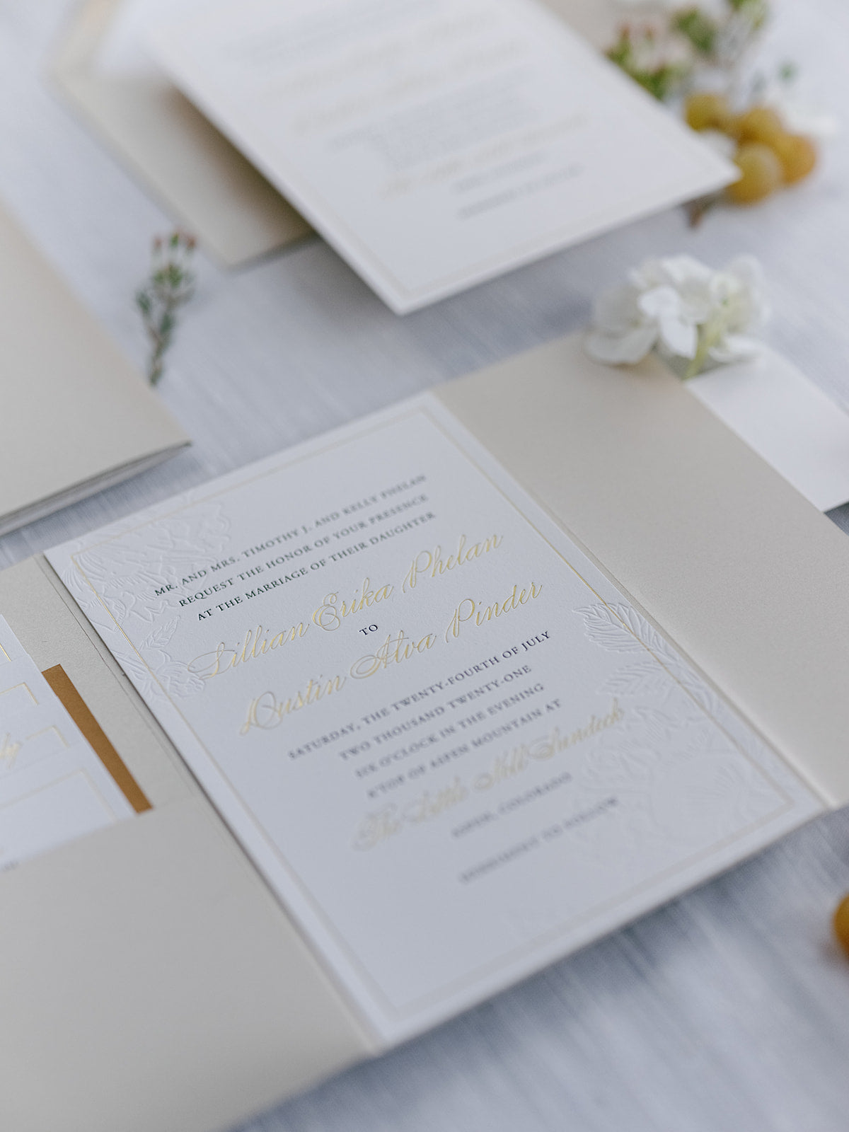 Wedding invitation card with gold text on a light background