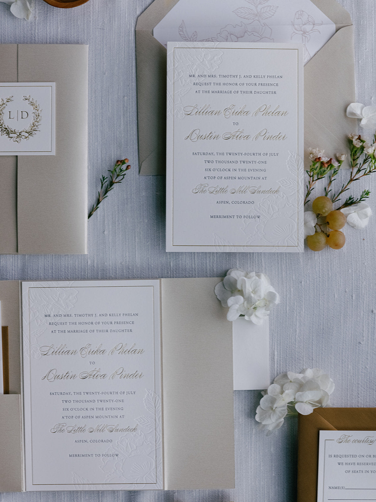 Wedding invitation card with floral elements on a textured surface