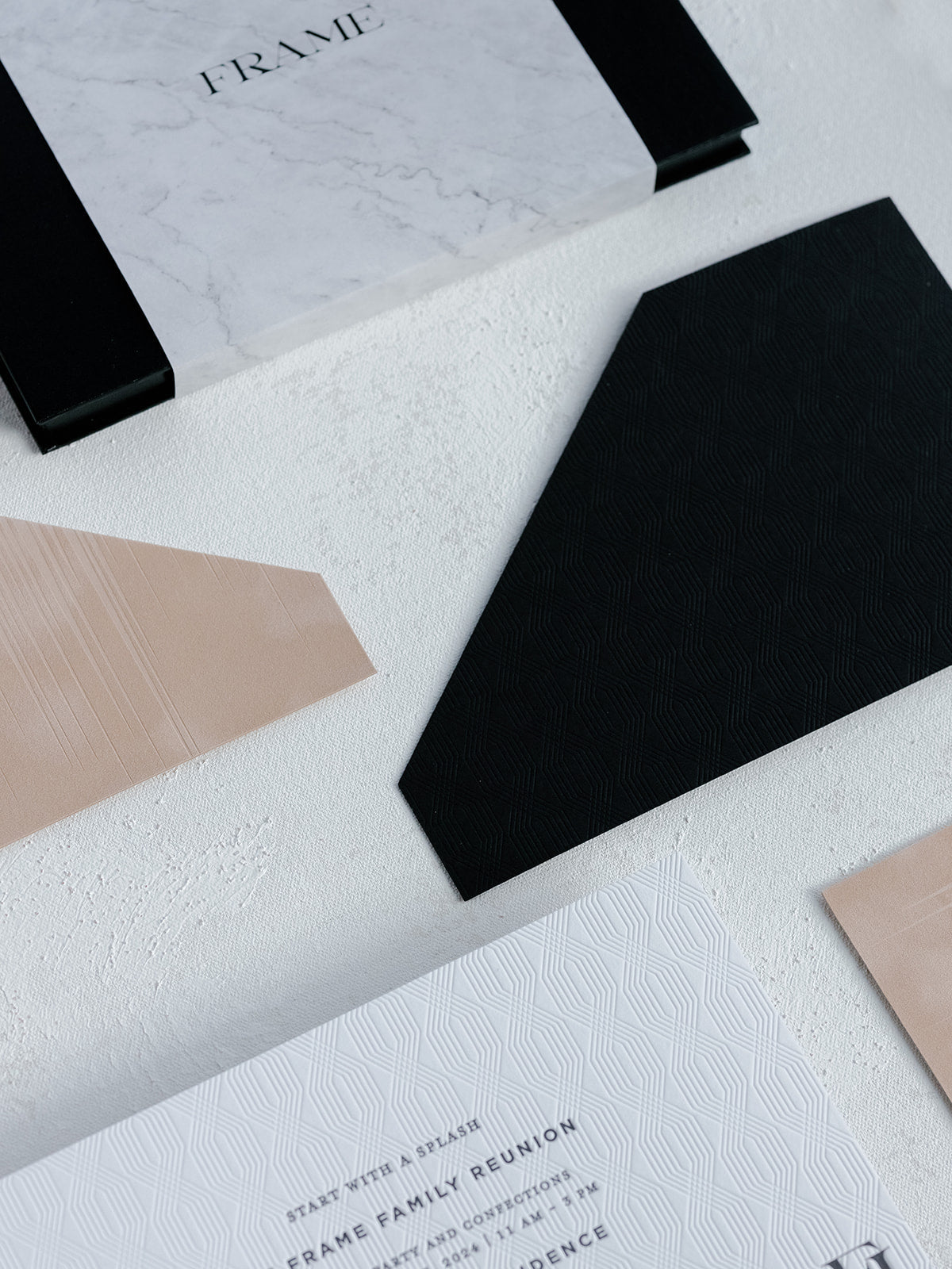 Geometrically shaped cards on a textured surface with 'FRAME' branding.
