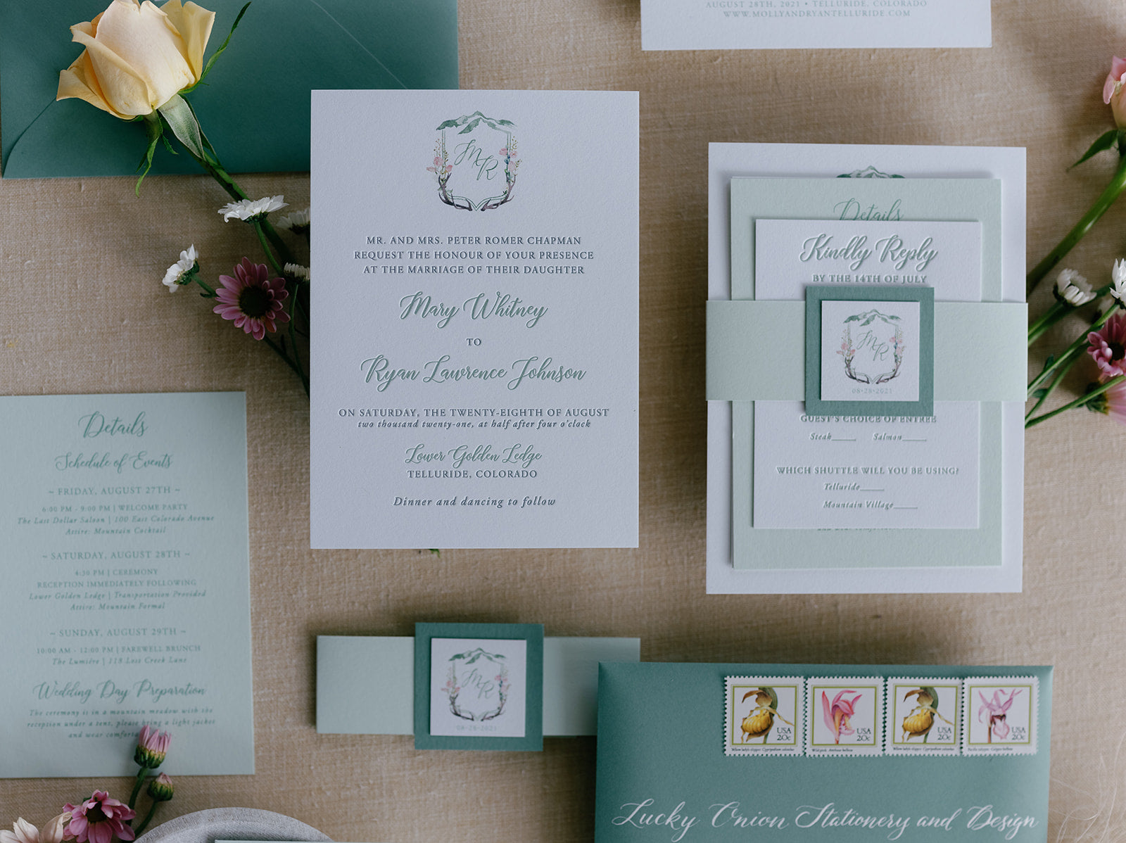 Wedding invitation set with floral decorations on a textured surface